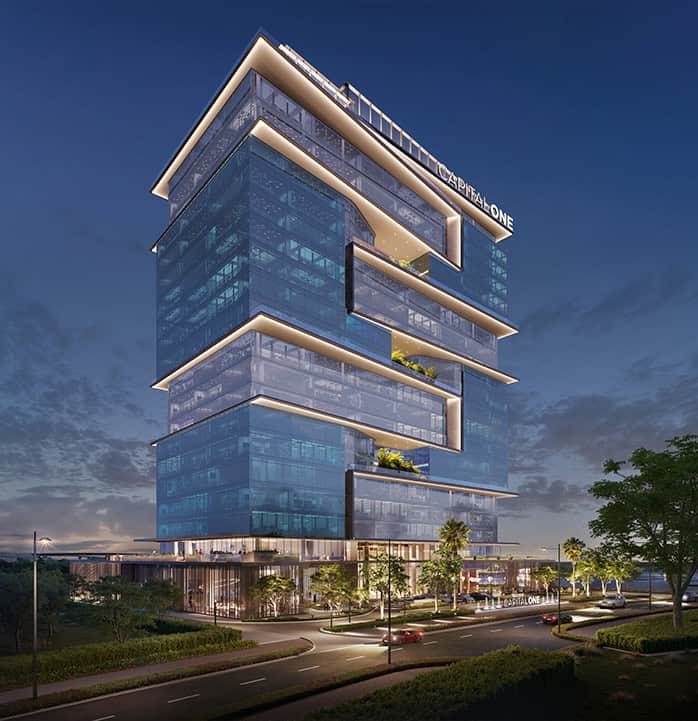 Modern Address Point Properties building with glass facade in Dubai at dusk, showcasing luxury commercial real estate.