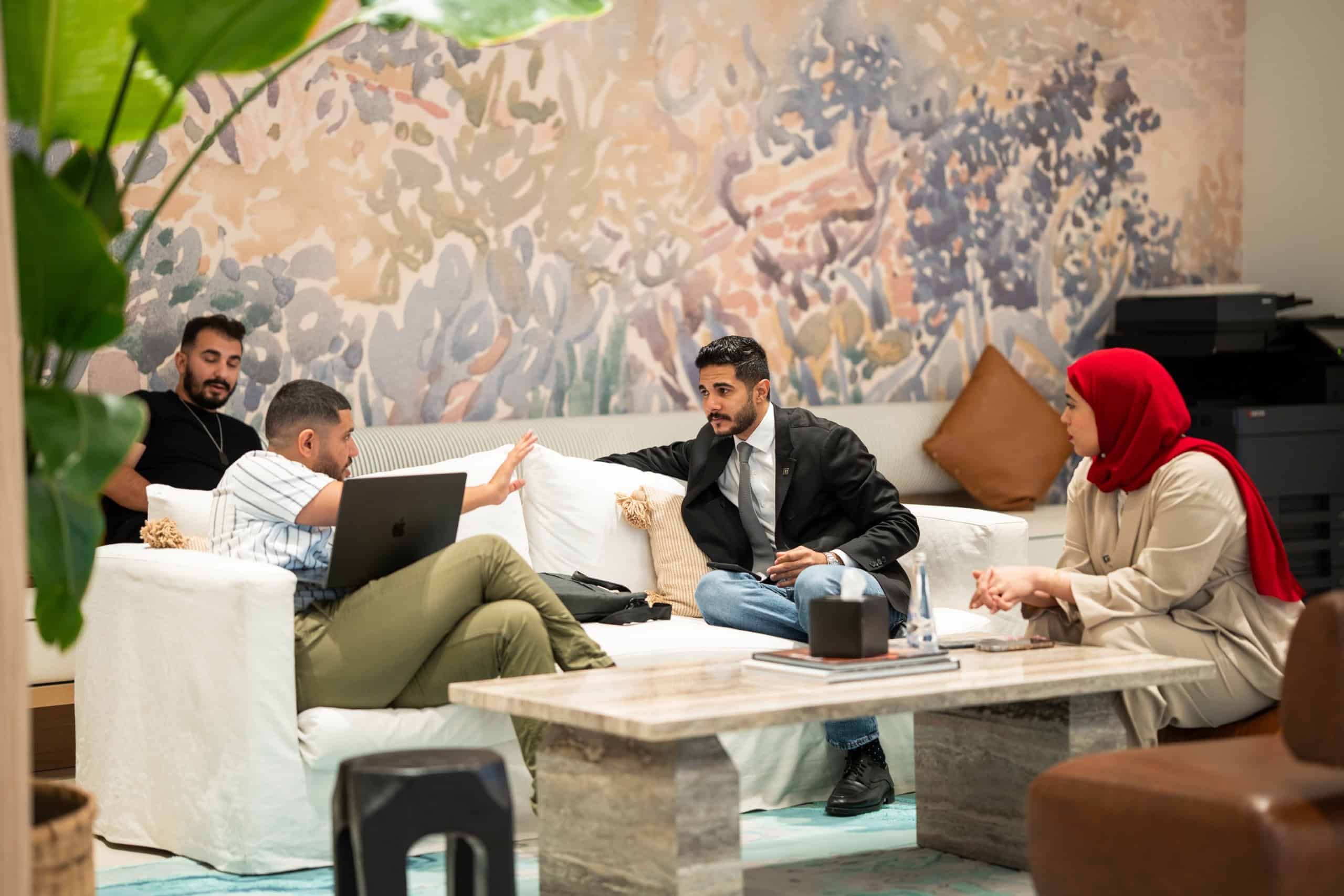 Investors in conversation with Address Point Properties agents in the Aldar lounge during the Aldar Roadshow