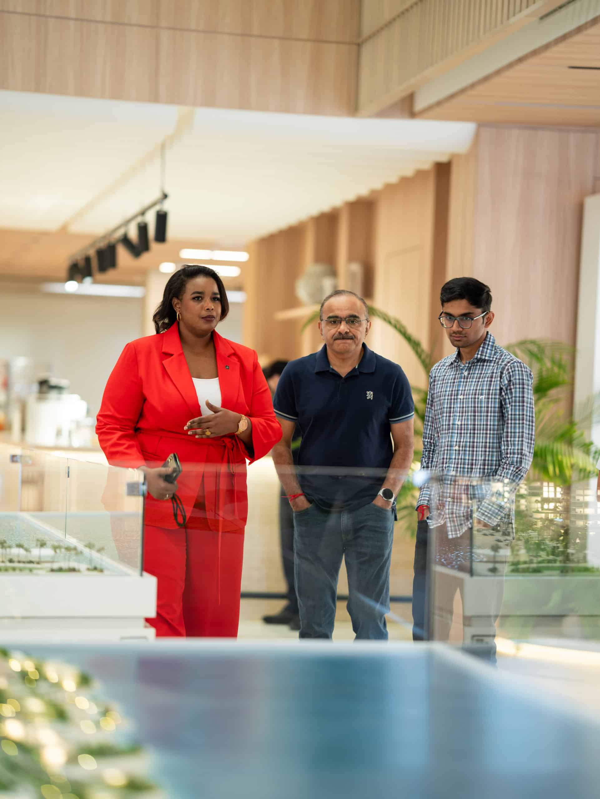 Address Point agent guiding a family of investors through Aldar project models