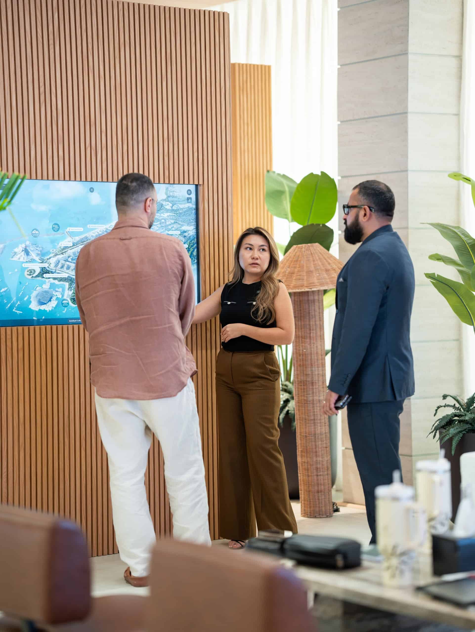 Address Point agent presenting Saadiyat Island Aldar projects on an interactive screen to guests